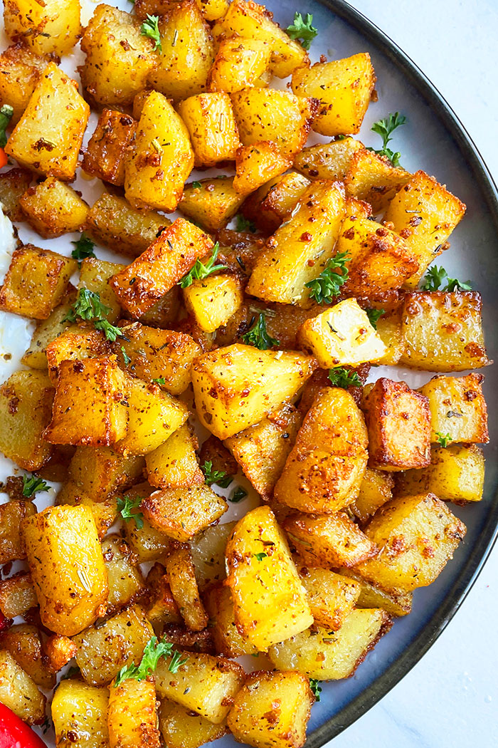 seasoned chopped up potatoes on a plate